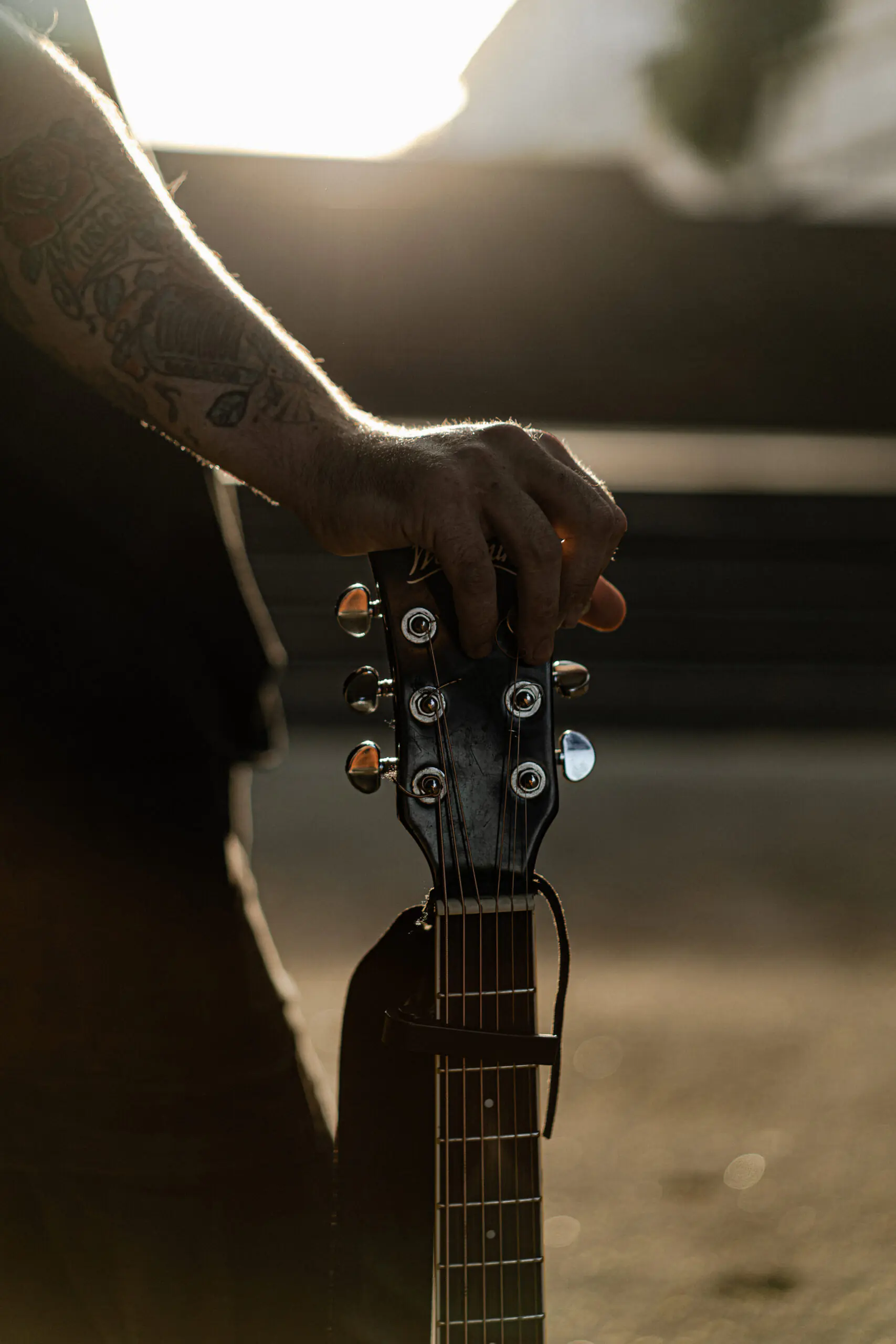 young man street musician plays the guitar and sings. Street mus